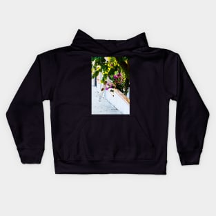 Dog staring at flowers Kids Hoodie